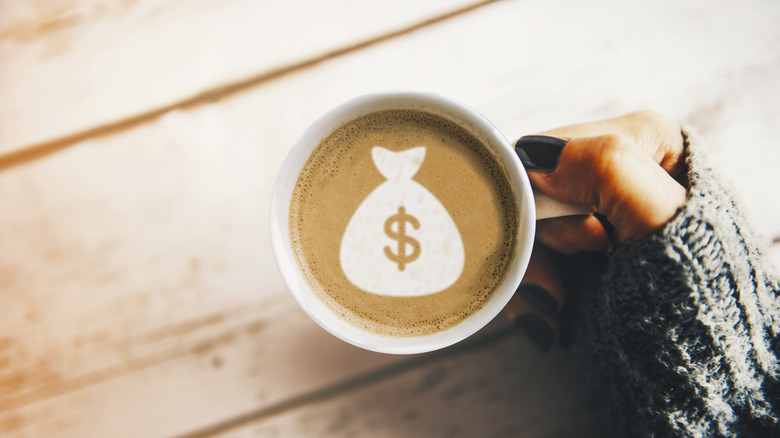 Girl with a cup of coffee with a money bag symbol.