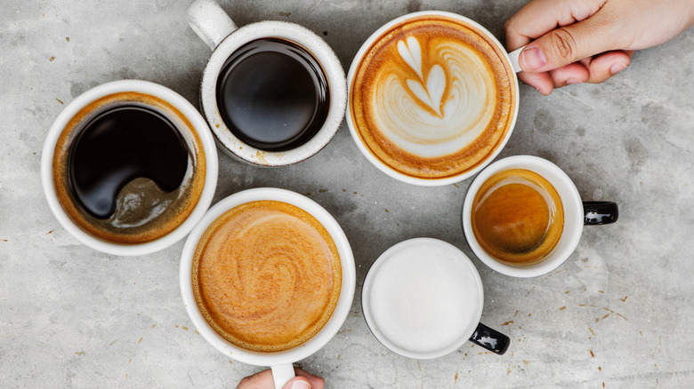Different cups of coffee beverages on a table.