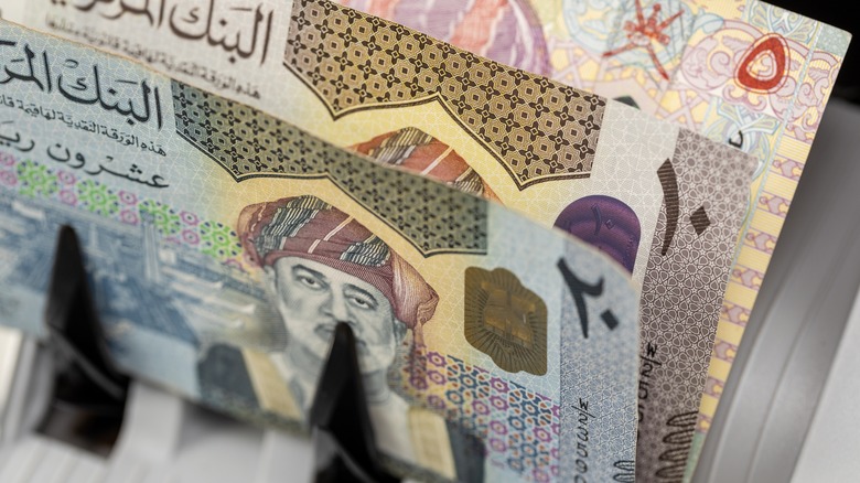 Omani rial coming out a money counter.
