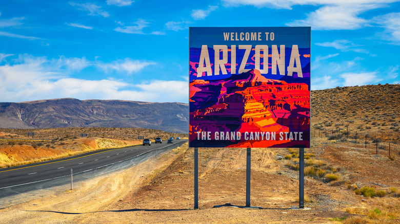 Welcome to Arizona State Sign with desert landscape situated along I-15 at the border with Utah.