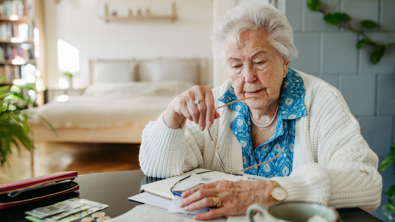 Senior woman calculating expenses