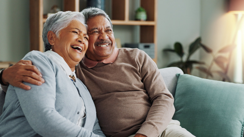 retired couple smiling and hugging