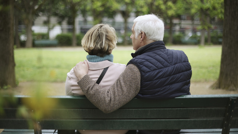 retired couple sitting on bench