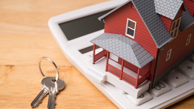 house figurine on a calculator