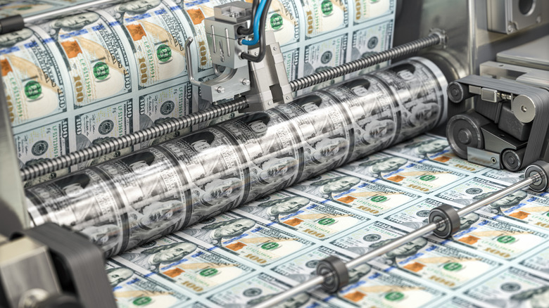 $100 bills being printed on a roll