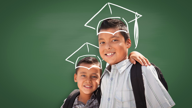 children with graduation caps drawn over heads