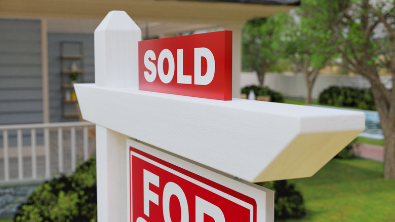 A "For sale" sign with a "sold" addition on top of it