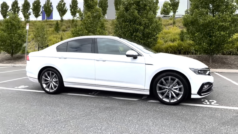 A white 2022 Volkswagen Passat on display in a dealership parking lot