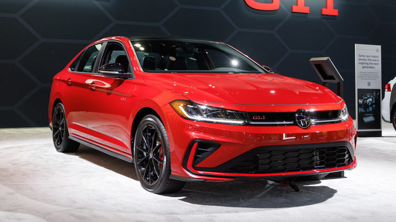 A red 2026 Volkswagen Jetta GLI on display at a car show