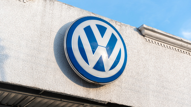 A Volkswagen dealership's sign against a blue sky