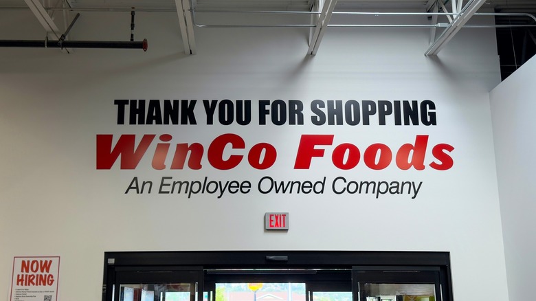 A "Thank You for Shopping at WinCo Foods" sign above a store exit