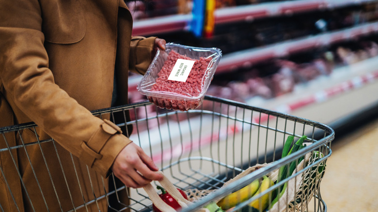 Young woman shopping fresh organic food in supermarket.