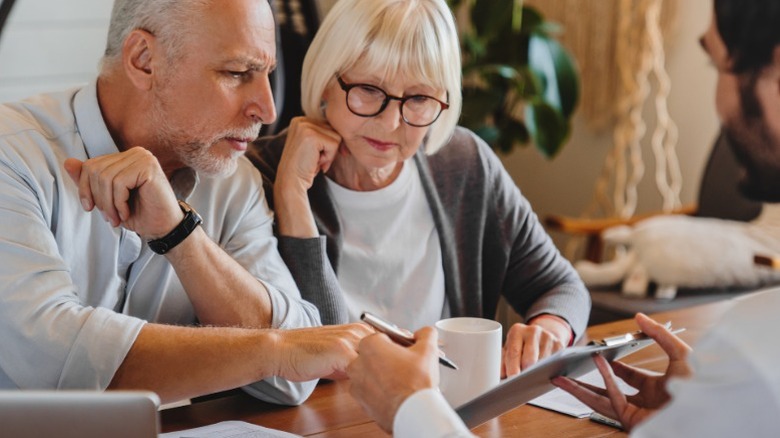 An older couple of retirement age consulting with a financial planner.