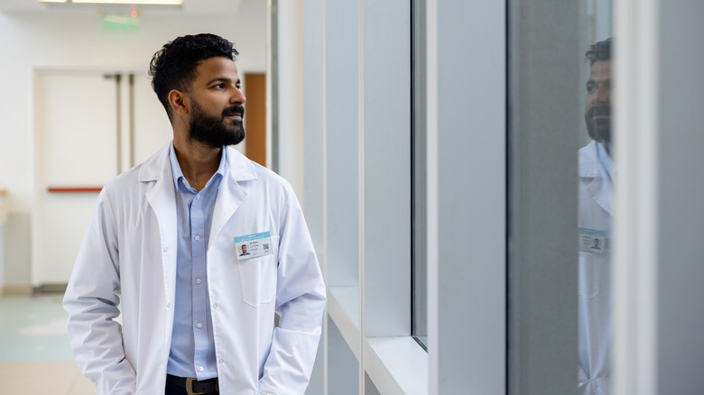 a medical resident looking out a window