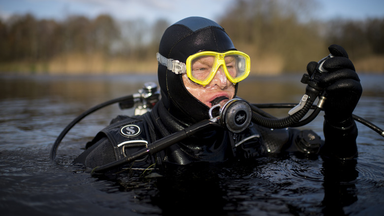 Ralf Oestmann, 46, prepares to dive for golf balls at a golf course