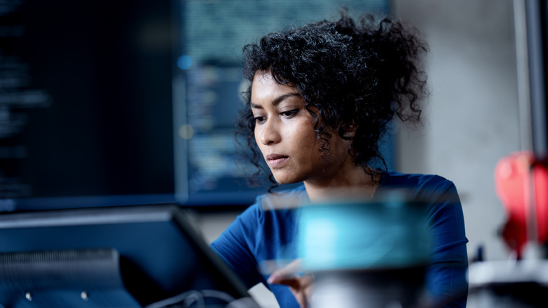 Woman intently working on a computer