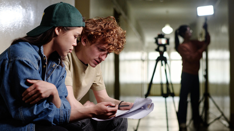 Young people looking over script