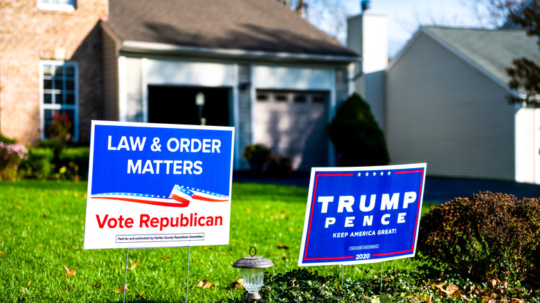Republican voter signs in a front lawn in front of a house.