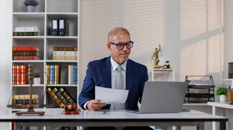 man in suit sitting at desk