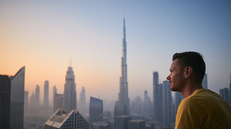 Man looking out at Dubai skyline