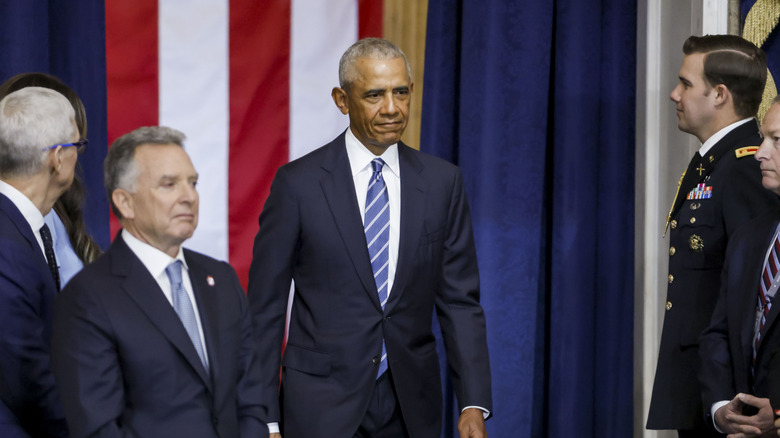Barack Obama in front of a flag at an event