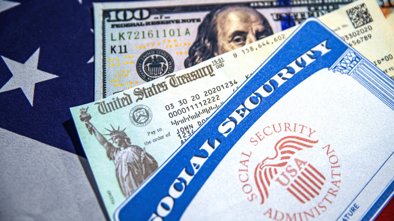 $100 bill under SSA check with Social Security card on top