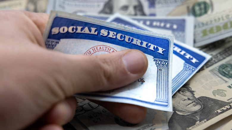 hand holding social security cards