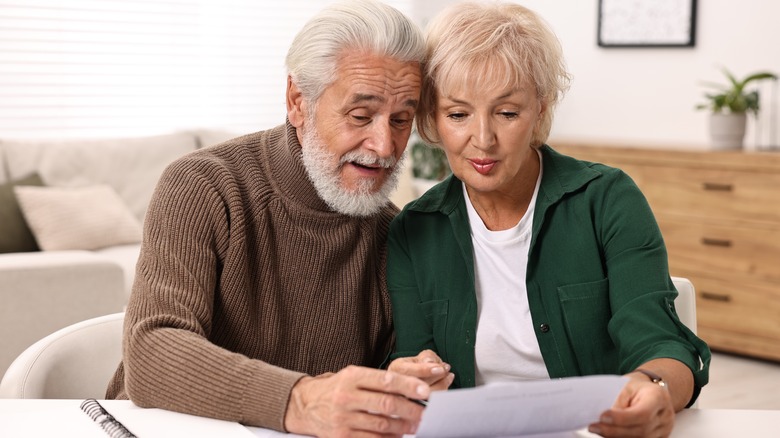 older couple at desk with paperwork