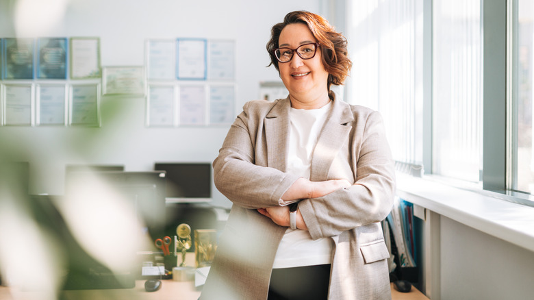 A middle-aged woman smiling in an office