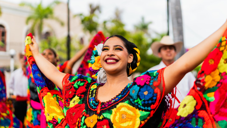 Young Mexican woman dancing at a festival