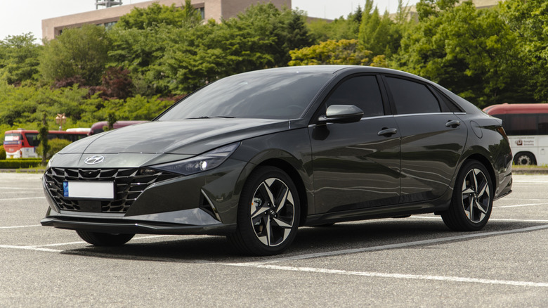A dark gray Hyundai Elantra hybrid parked in a parking lot.