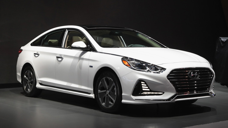 White Hyundai Sonata on display at a car show.