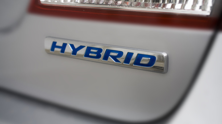 Close-up of a tail light with a HYBRID symbol below it