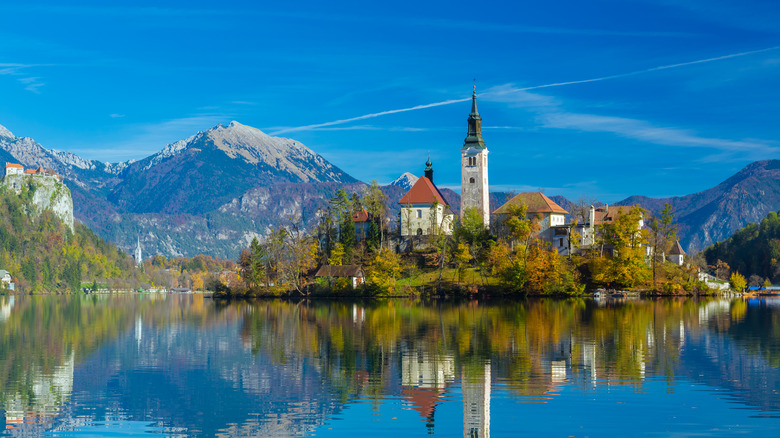 Reflection of Lake Bled island with mountains in the background