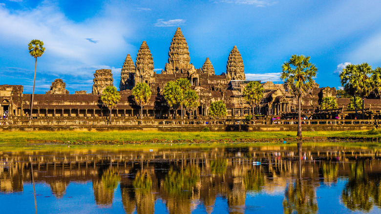 Famous Cambodian landmark and tourist attraction Angkor Wat with reflection in water near Siem Reap, Cambodia.