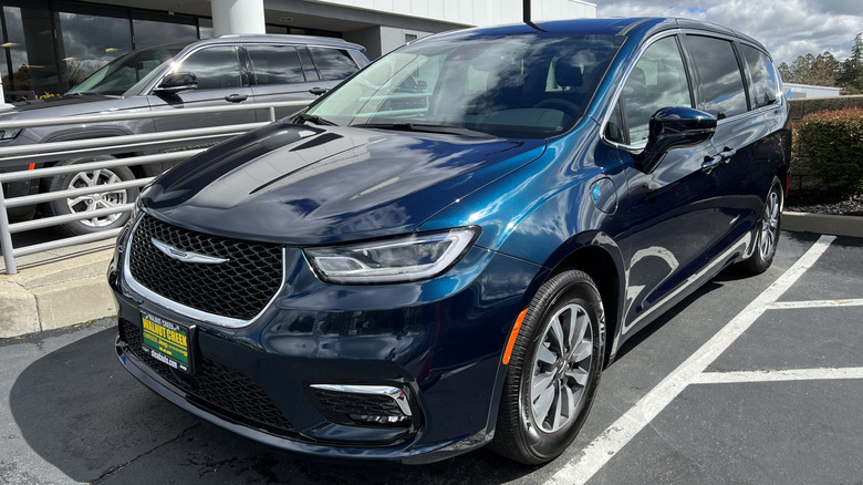 Blue Chrysler Pacifica Hybrid parked at a dealership