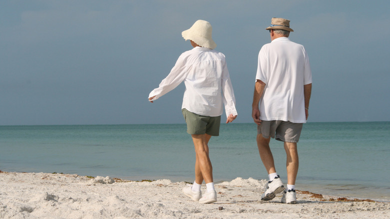 Older couple walking along the beach