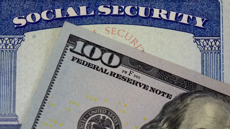 Social Security card with $100 bill in front