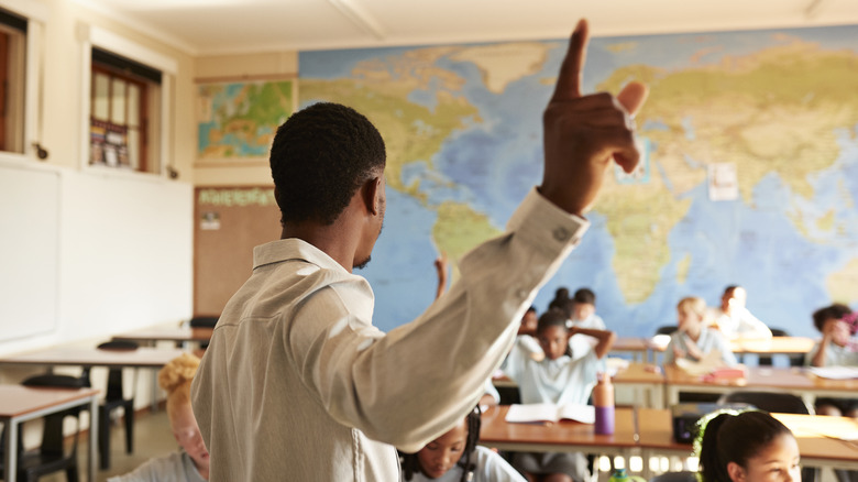 Teacher pointing finger in front of class