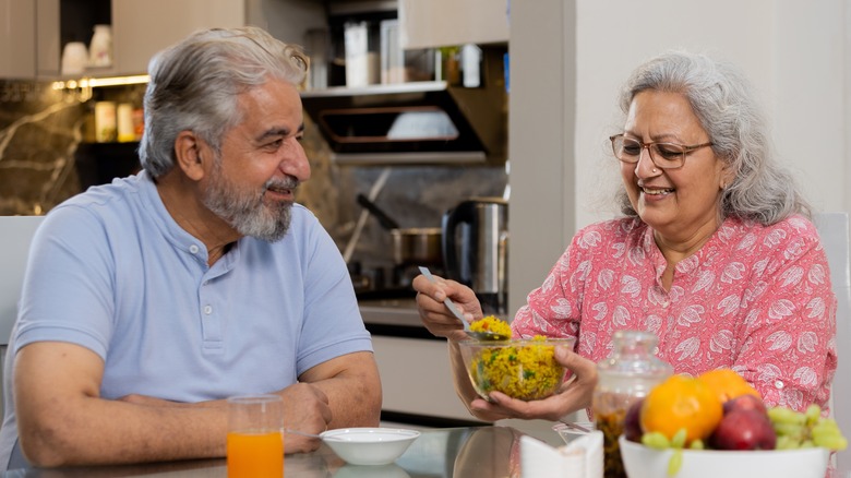 Senior couple eating dinner together at table