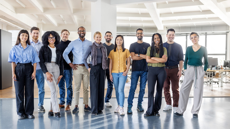 Line of coworkers standing and smiling