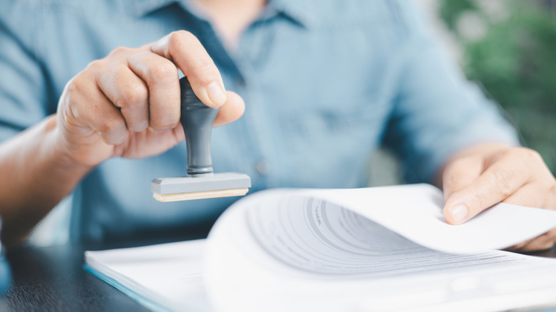 Loan officers stamps a document