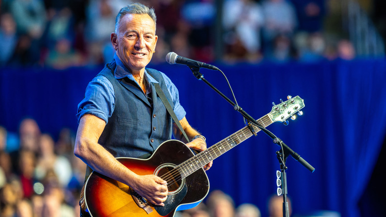 Bruce Springsteen playing guitar on stage