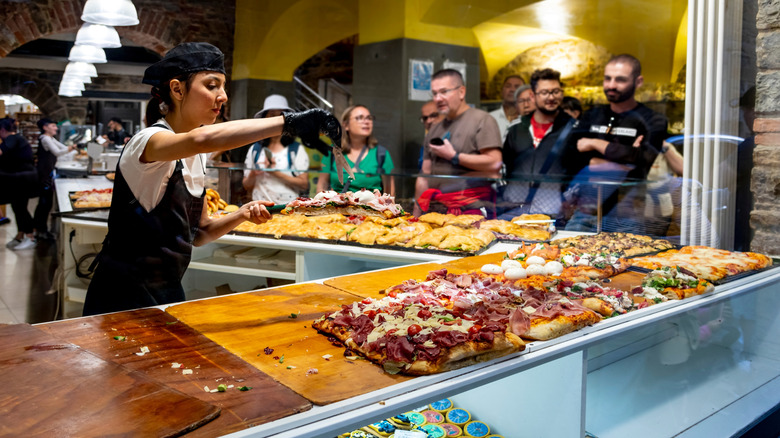 Customers standing in line at a casual eatery in Italy