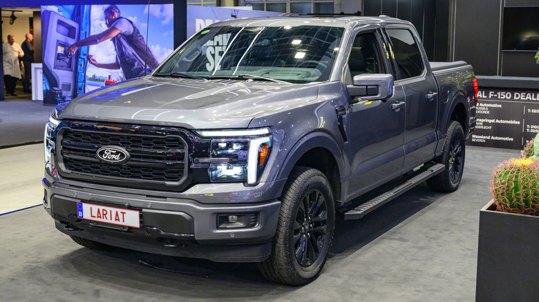 A silver 2026 Ford F-150 on display at a car show