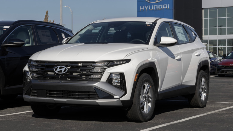 A white 2026 Hyundai Tucson parked outside of a Hyundai dealership