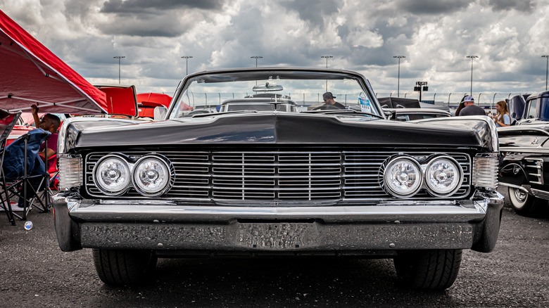 Classic car parked outside under clouds