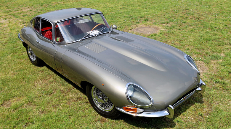 A silver Jaguar E-Type coupe