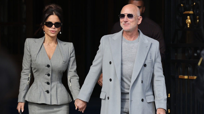 Jeff Bezos and his wife holding hands and walking