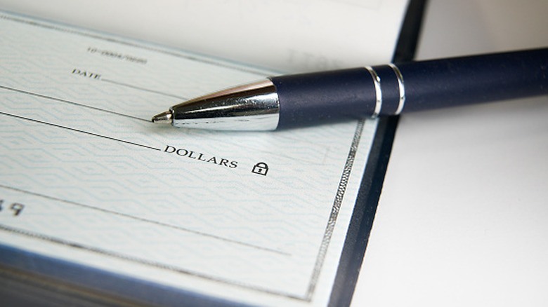closeup of a check and pen